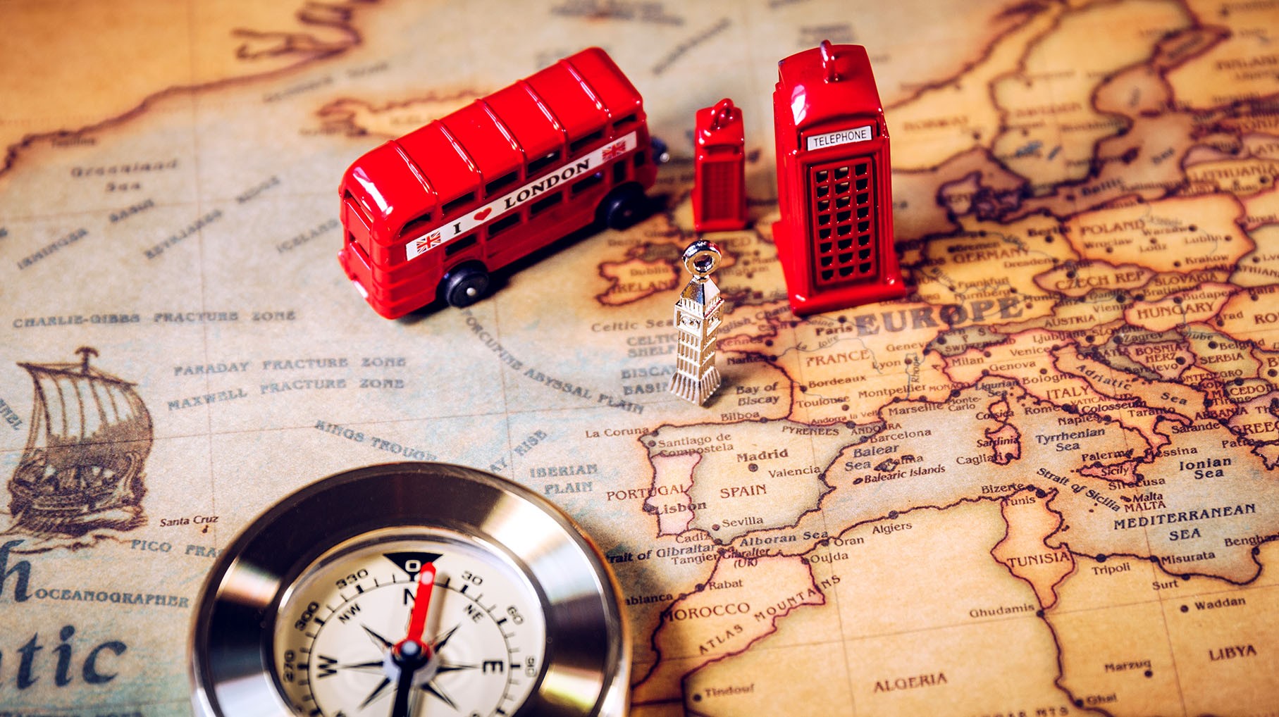 Red bus toy, compass, map