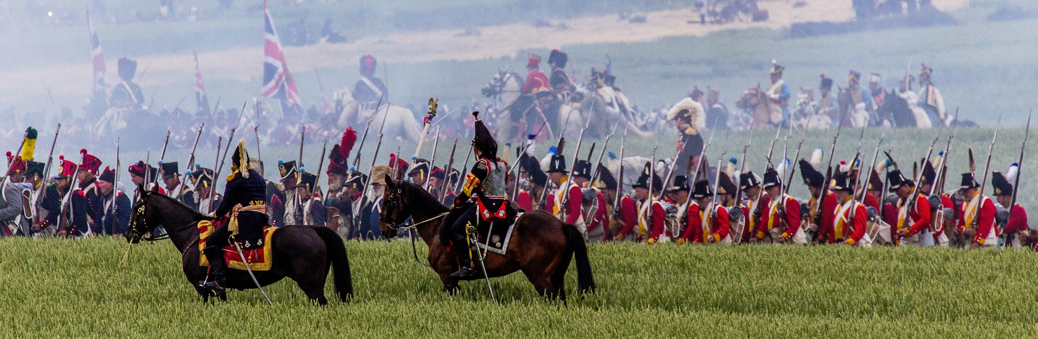 Four images of a military parade in 18th century uniforms