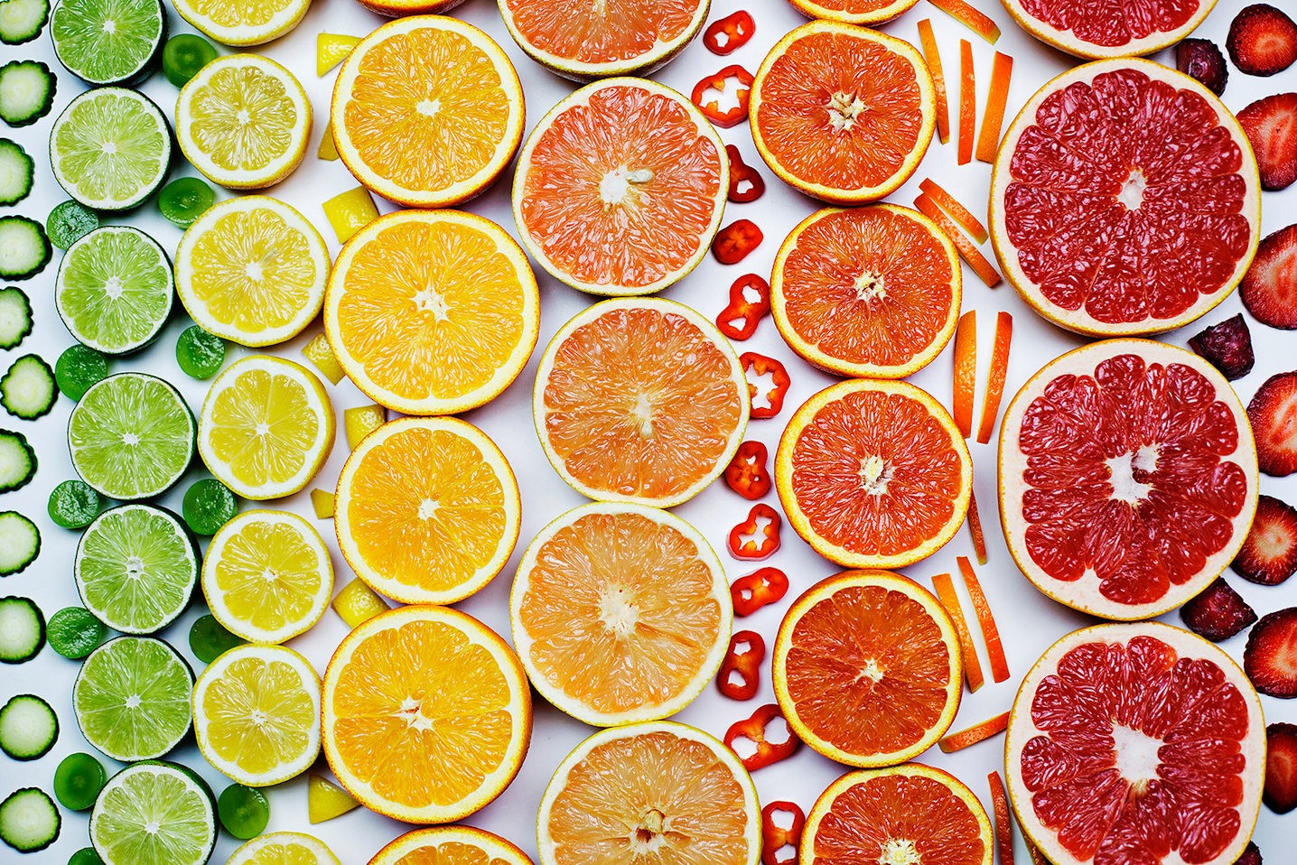 Colorful citrus fruits arranged in rows