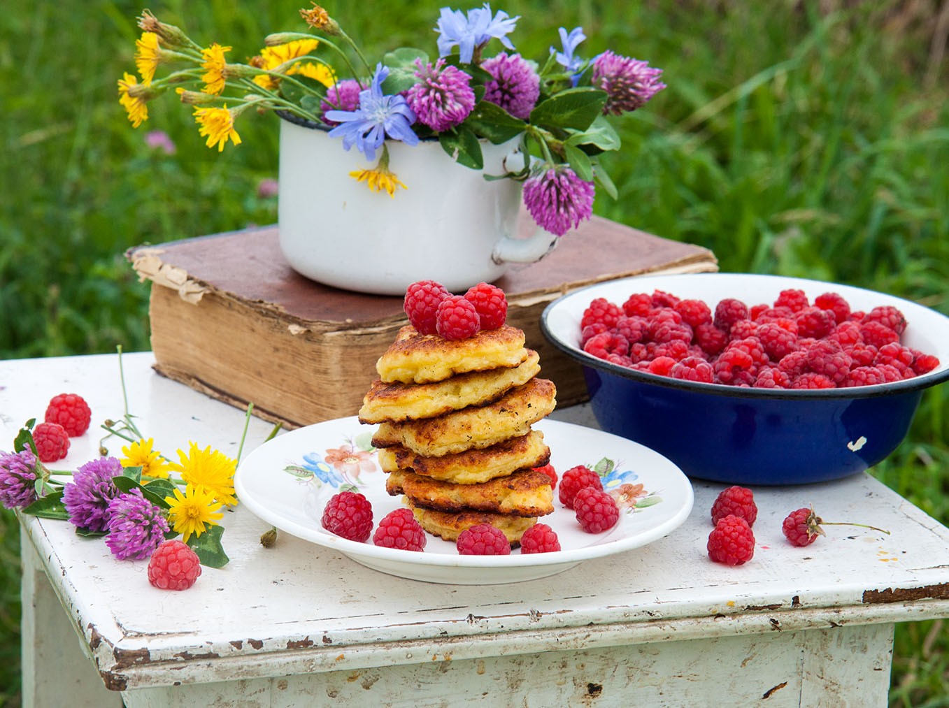 Table raspberries cake plate flowers blue jar