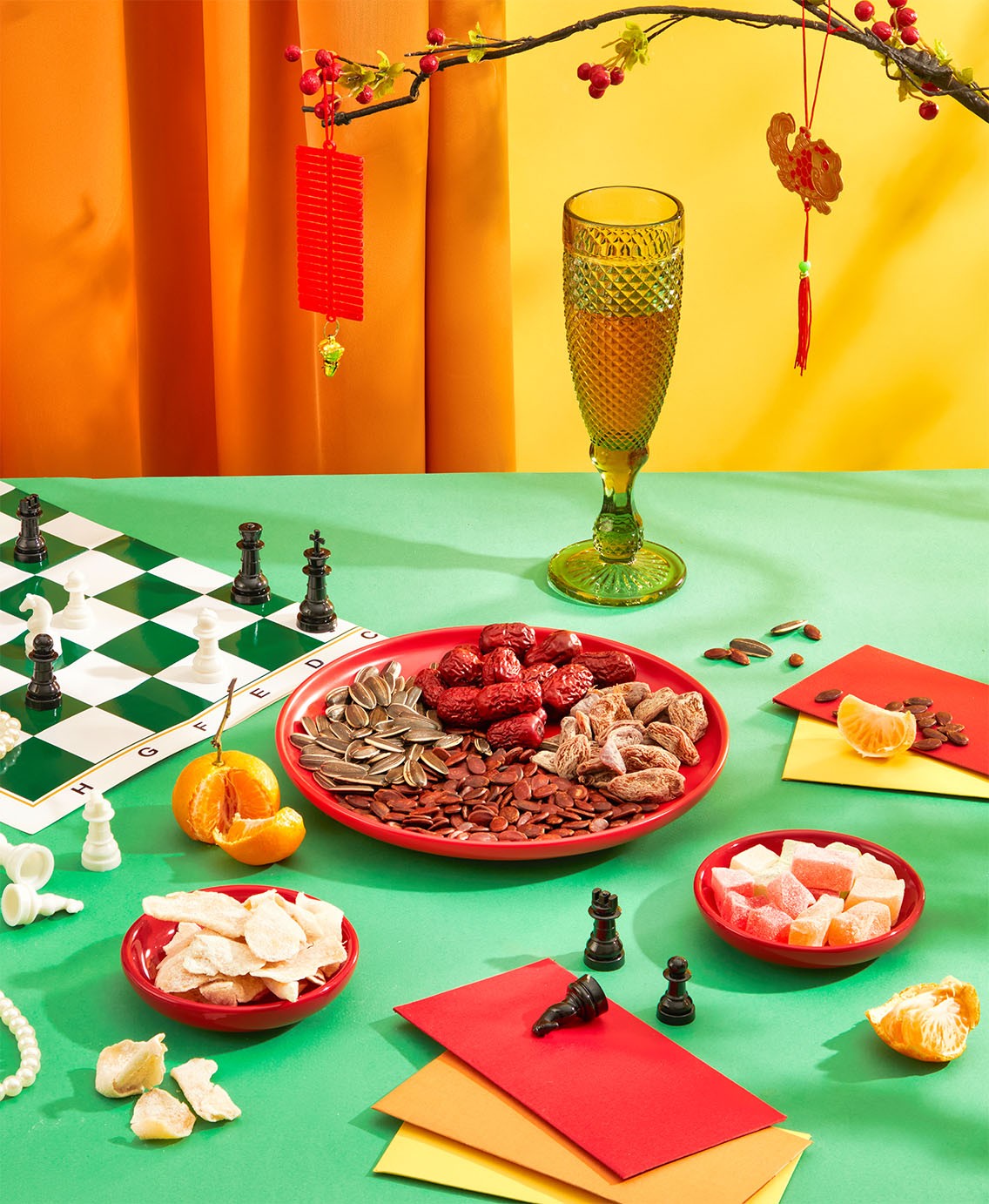 Festive chess set up, wine glass, candies, chess pieces