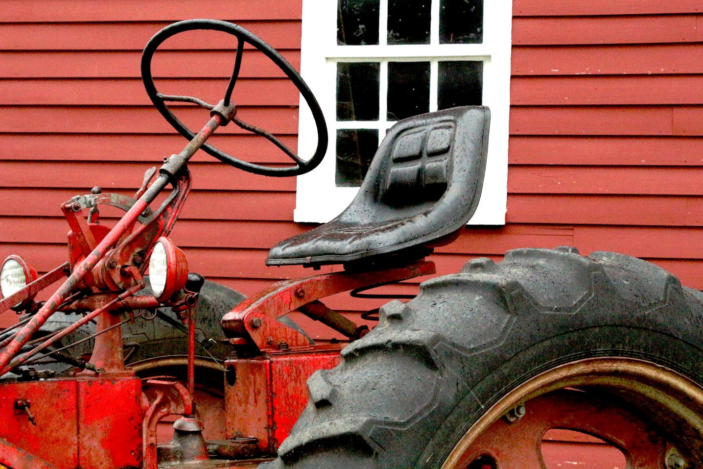 Old fashioned tractor with steering wheel on right