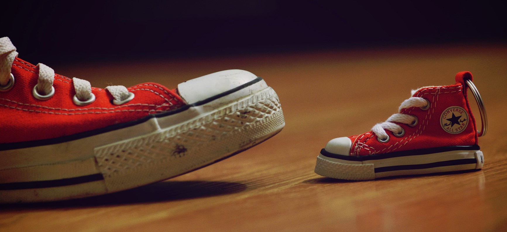 Small red shoes next to large red shoes