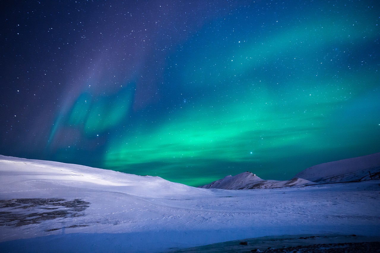 Aurora lights above snowy mountains