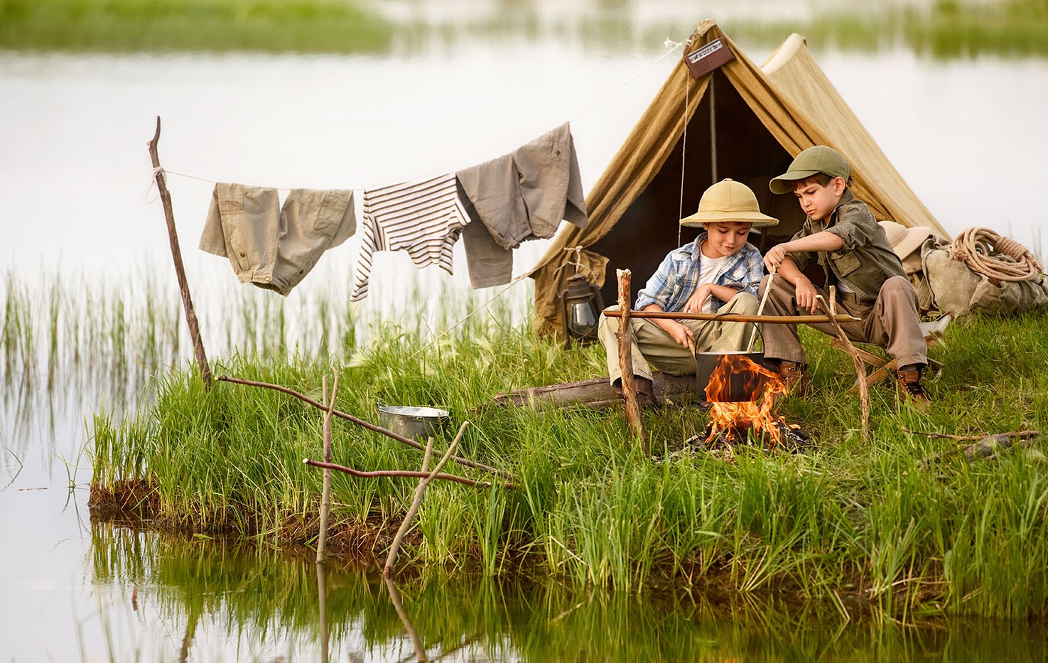 Two people sit in tent