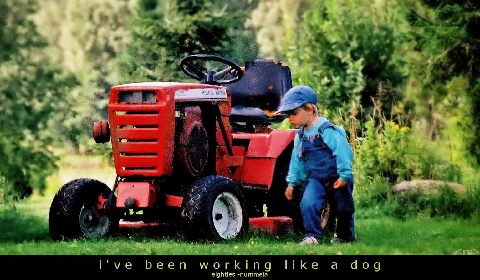 Boy standing by tractor