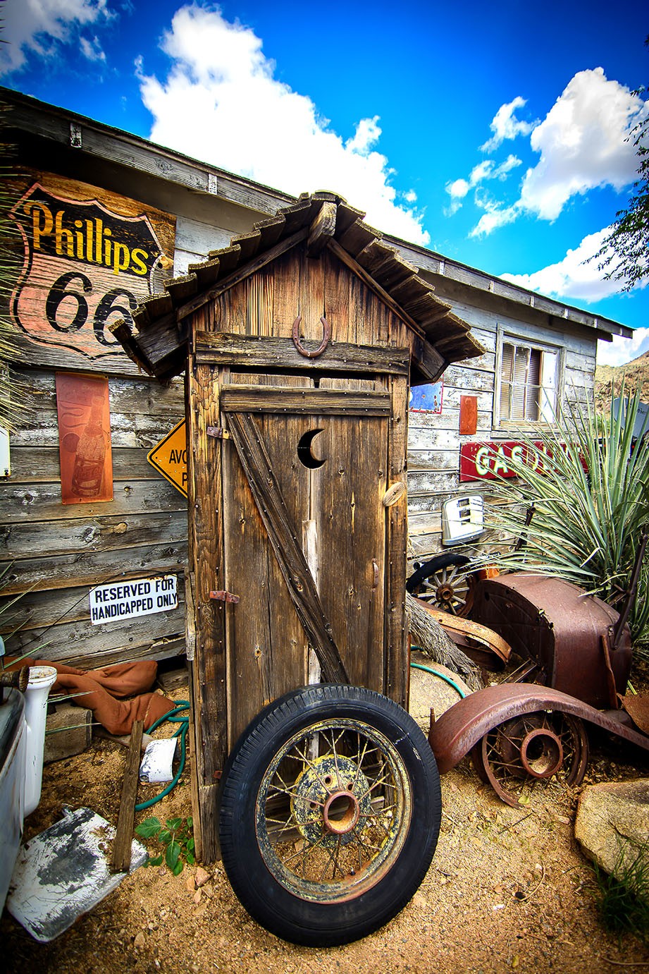 Abandoned outhouse with tire