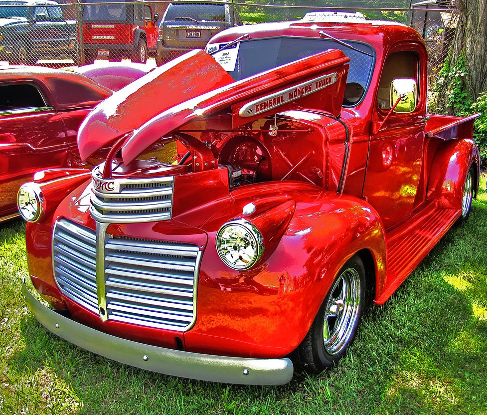Old red truck parked in lot