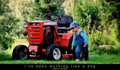 Boy standing by tractor